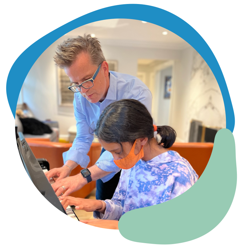 Gene Kelly teaching a student on the piano